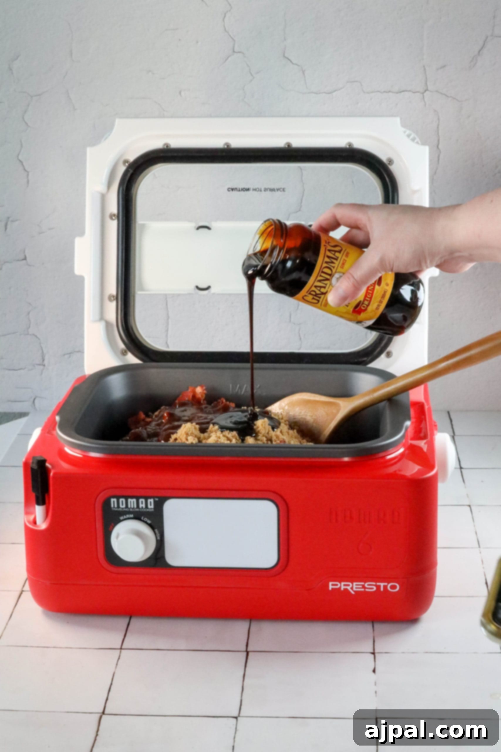 A person is preparing the best bean bake in a red microwave oven.