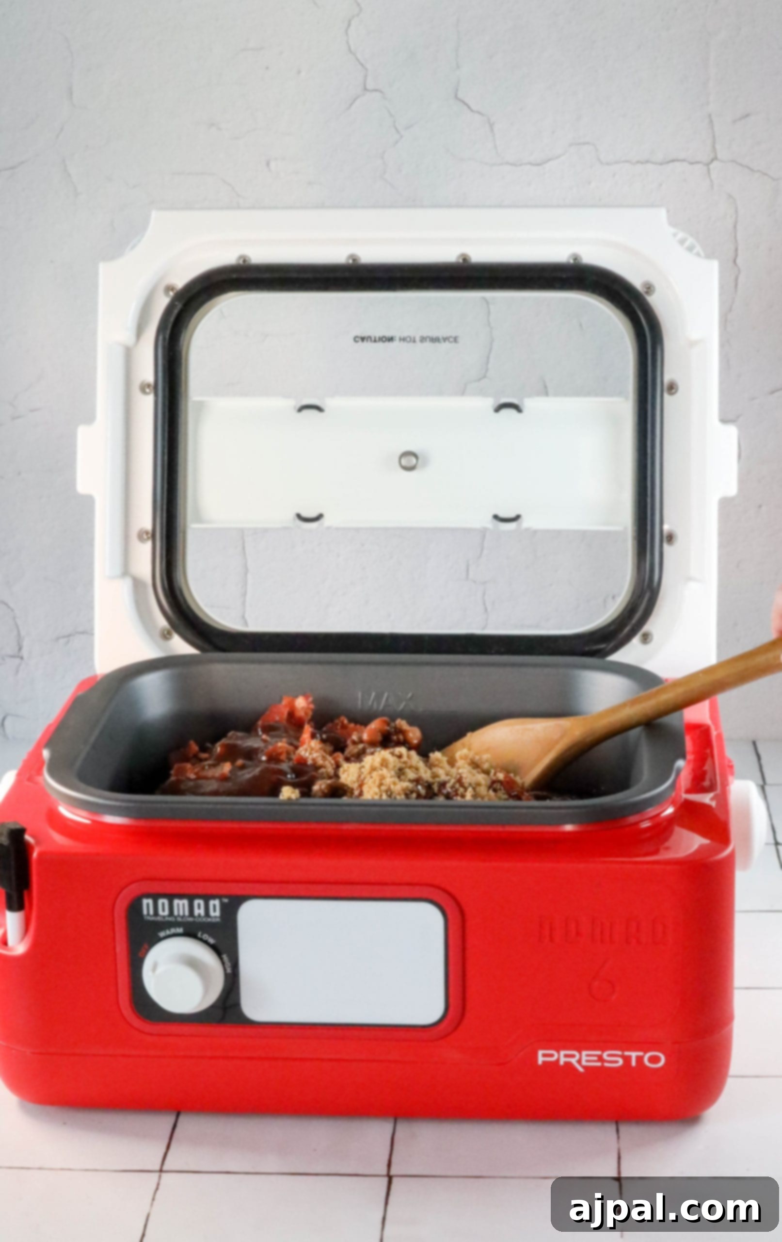 A person is preparing a delicious bean bake in a red microwave oven.