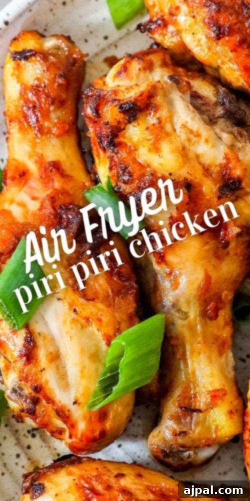 A close-up shot of perfectly cooked air-fried piri piri chicken, highlighting its crispy skin and rich color, ready to be enjoyed.