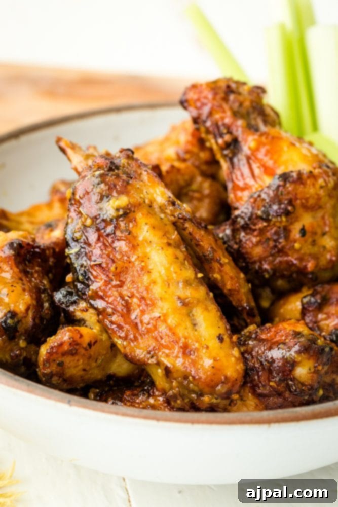 Air Fried Honey Mustard Glazed Wings 7 Bowl of air fryer honey mustard chicken wings with celery sticks.