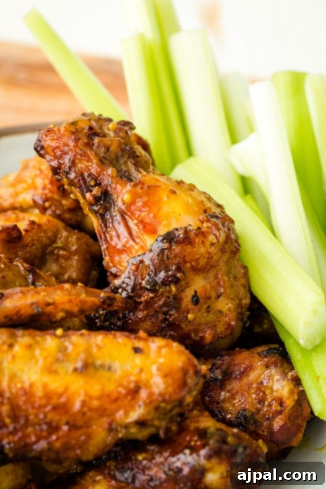 Air Fried Honey Mustard Glazed Wings 5 Plate of honey mustard wings served with fresh celery sticks.