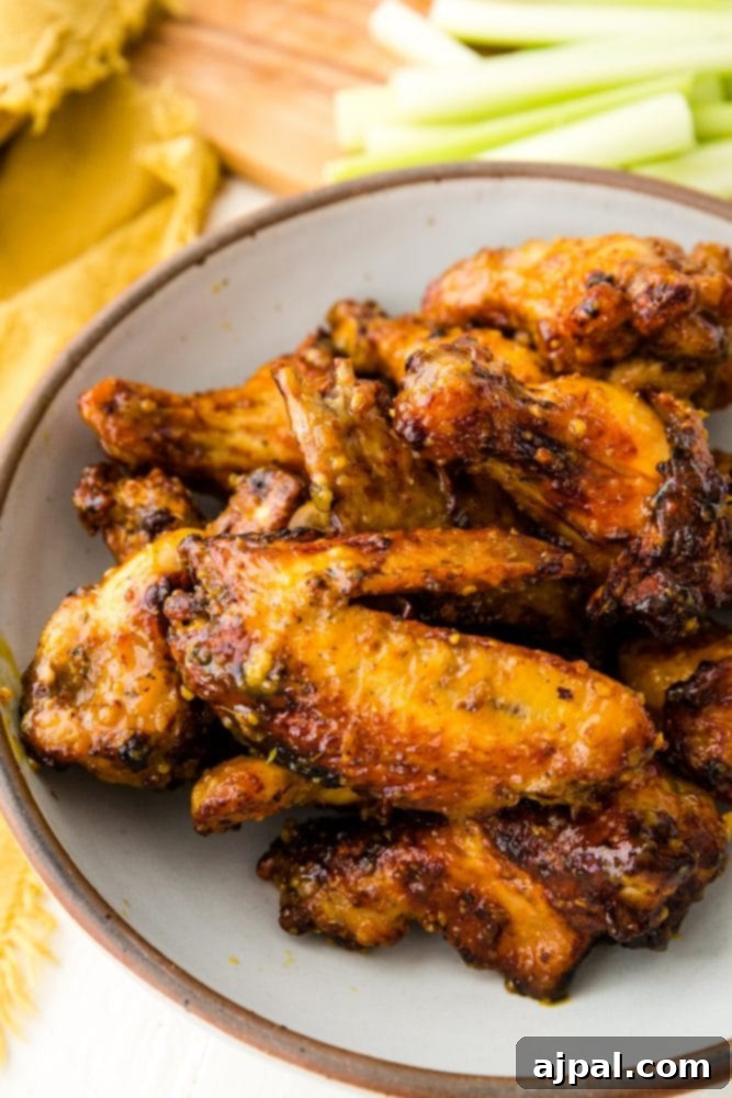 Air Fried Honey Mustard Glazed Wings 6 Close-up of a plate of perfectly cooked sticky honey mustard chicken wings.
