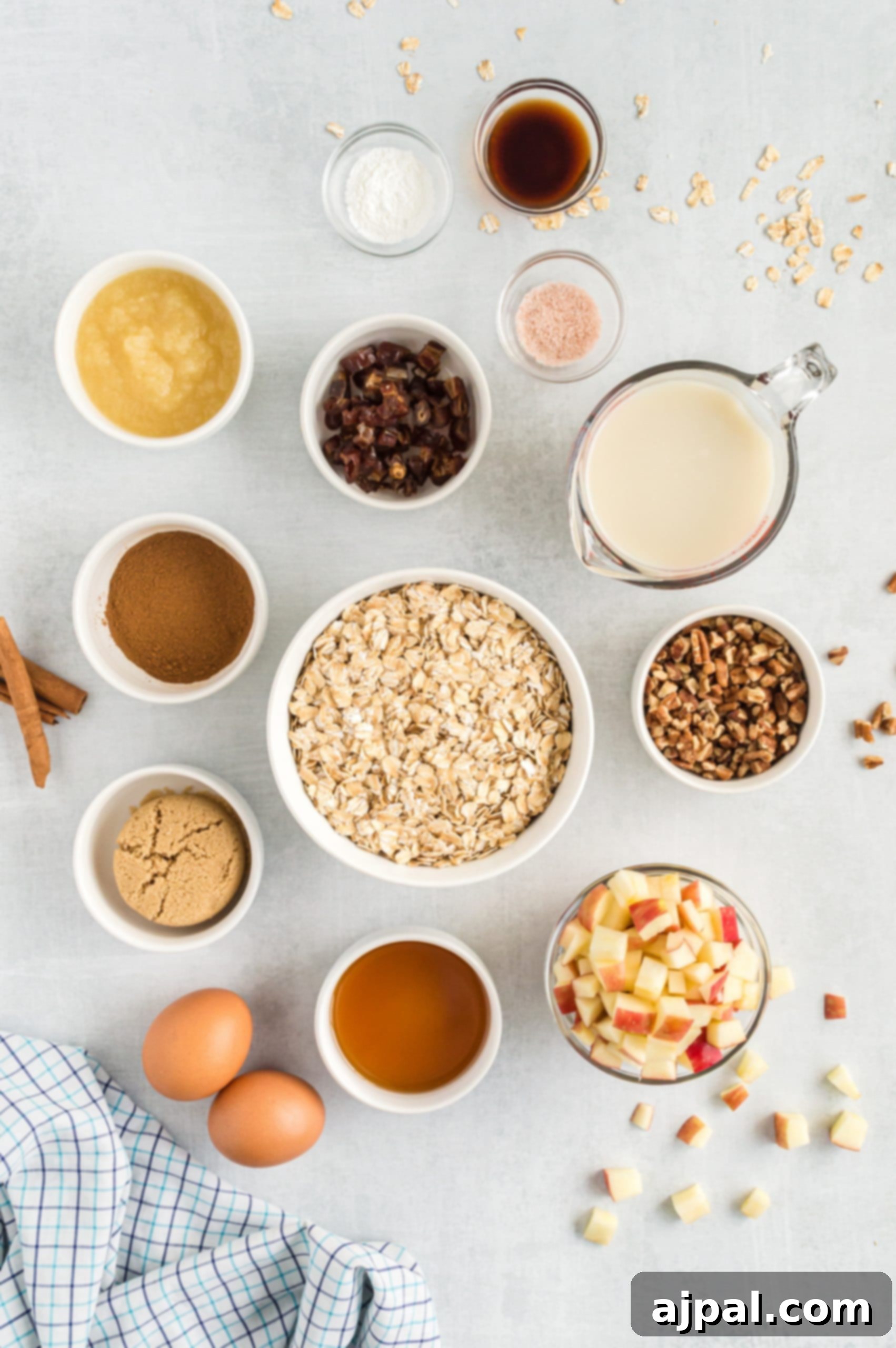 A vibrant collection of ingredients including crisp apples and hearty oatmeal, thoughtfully arranged on a stylish gray background.