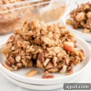 A close-up of easy baked oatmeal with fresh apples and pecans, perfectly golden brown.