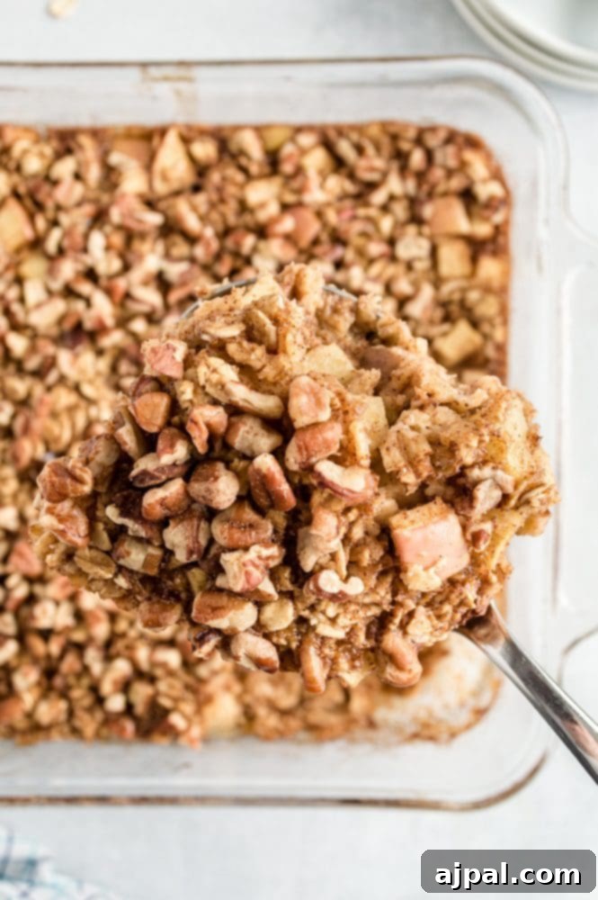 A tantalizing apple baked oatmeal with a crunchy granola topping, nestled perfectly in a glass baking dish.