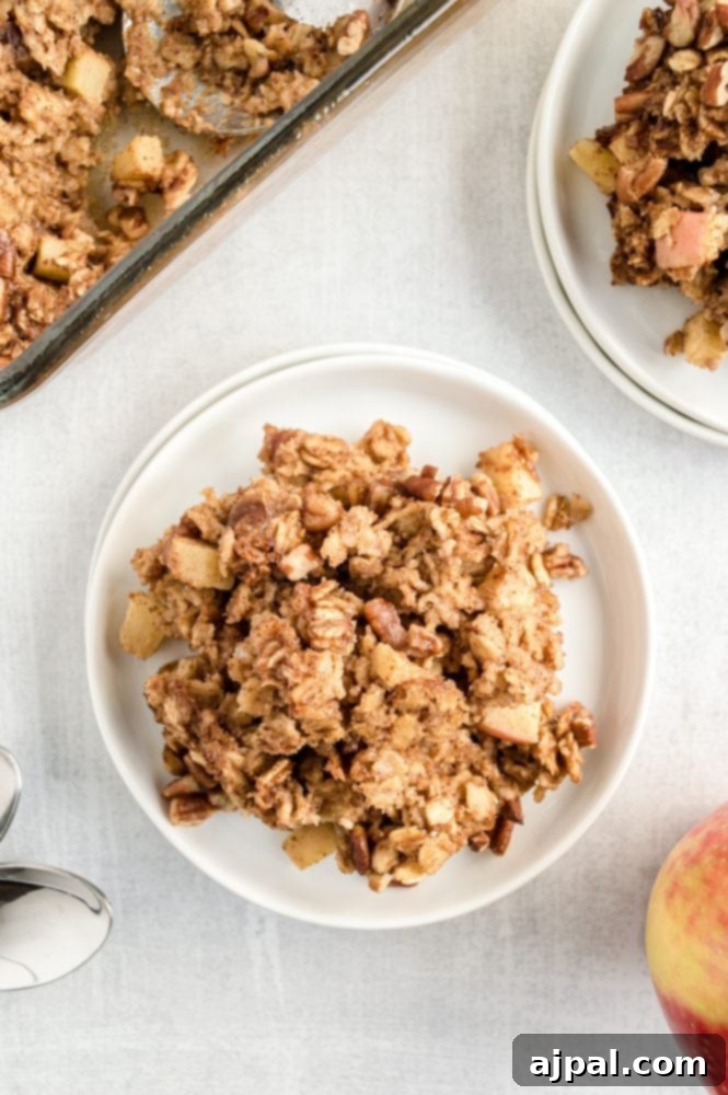 A single portion of baked oatmeal with apples and pecans, beautifully plated and ready to be enjoyed.