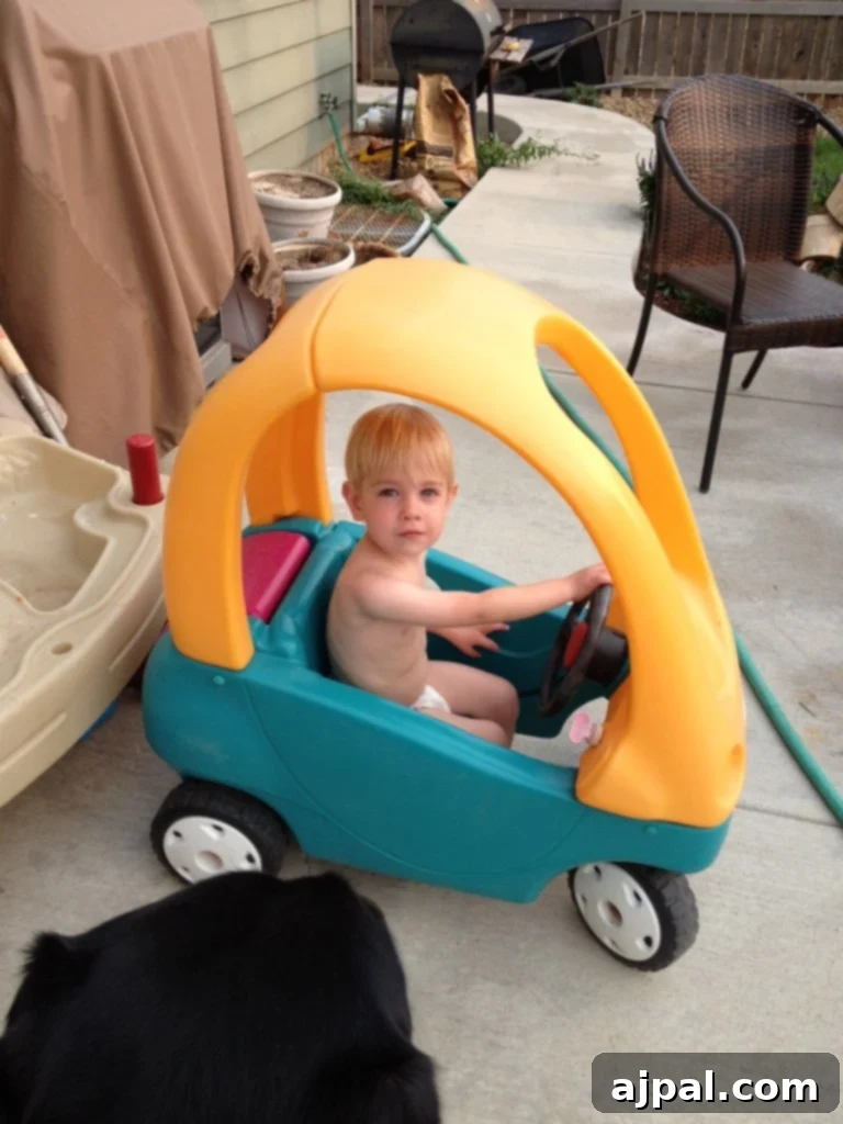 picture of a toddler in a plastic car