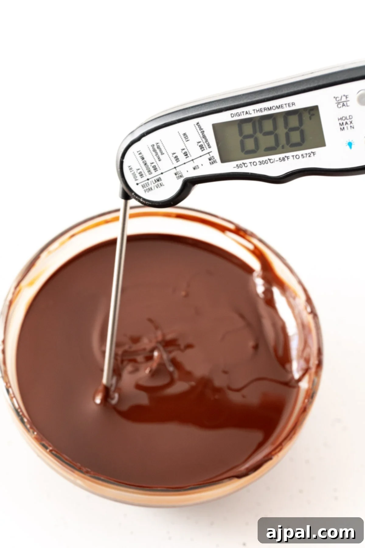 Decadent Peanut Butter Hot Cocoa Bombs 12 Chocolate in a glass bowl registering 89.8 degrees, indicating perfectly tempered chocolate.