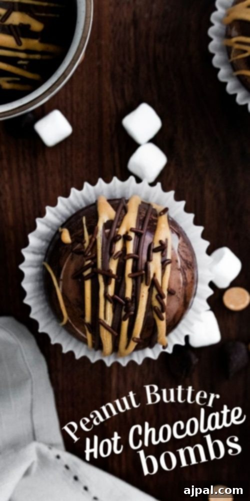 Decadent Peanut Butter Hot Cocoa Bombs 24 Peanut butter hot chocolate bombs with peanut butter and chocolate sprinkles, marshmallows in the background, beautifully presented.