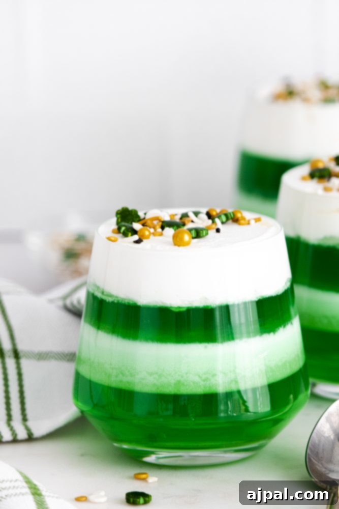 Easy, layered green St. Patrick’s Day jello shots in cups.