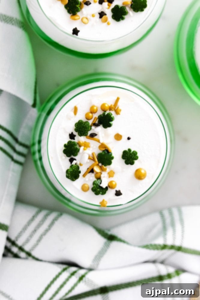 Saint Patrick’s Day desserts featuring layered green jello and whipped cream cups.