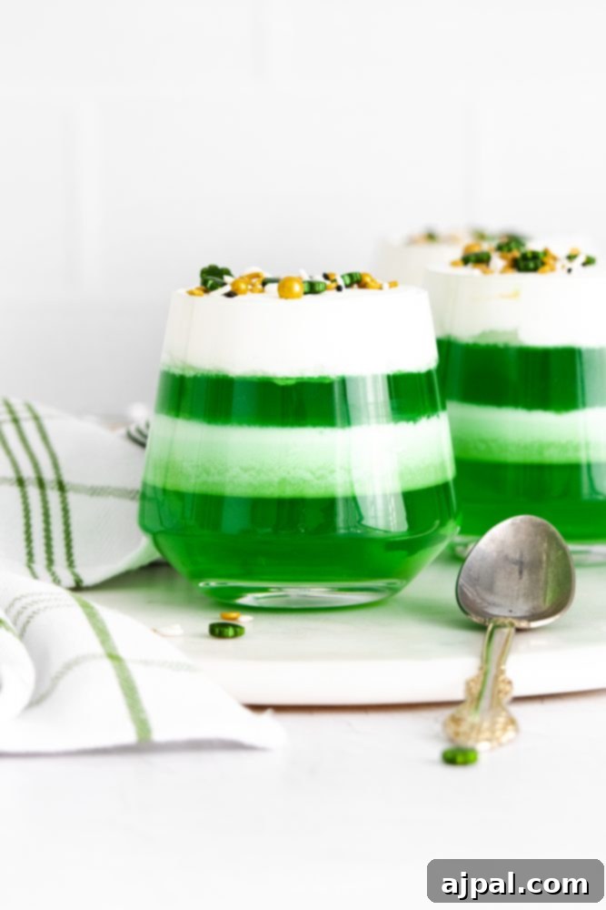 Saint Patrick’s Day themed jello cups with layered green jello and jello whipped cream.