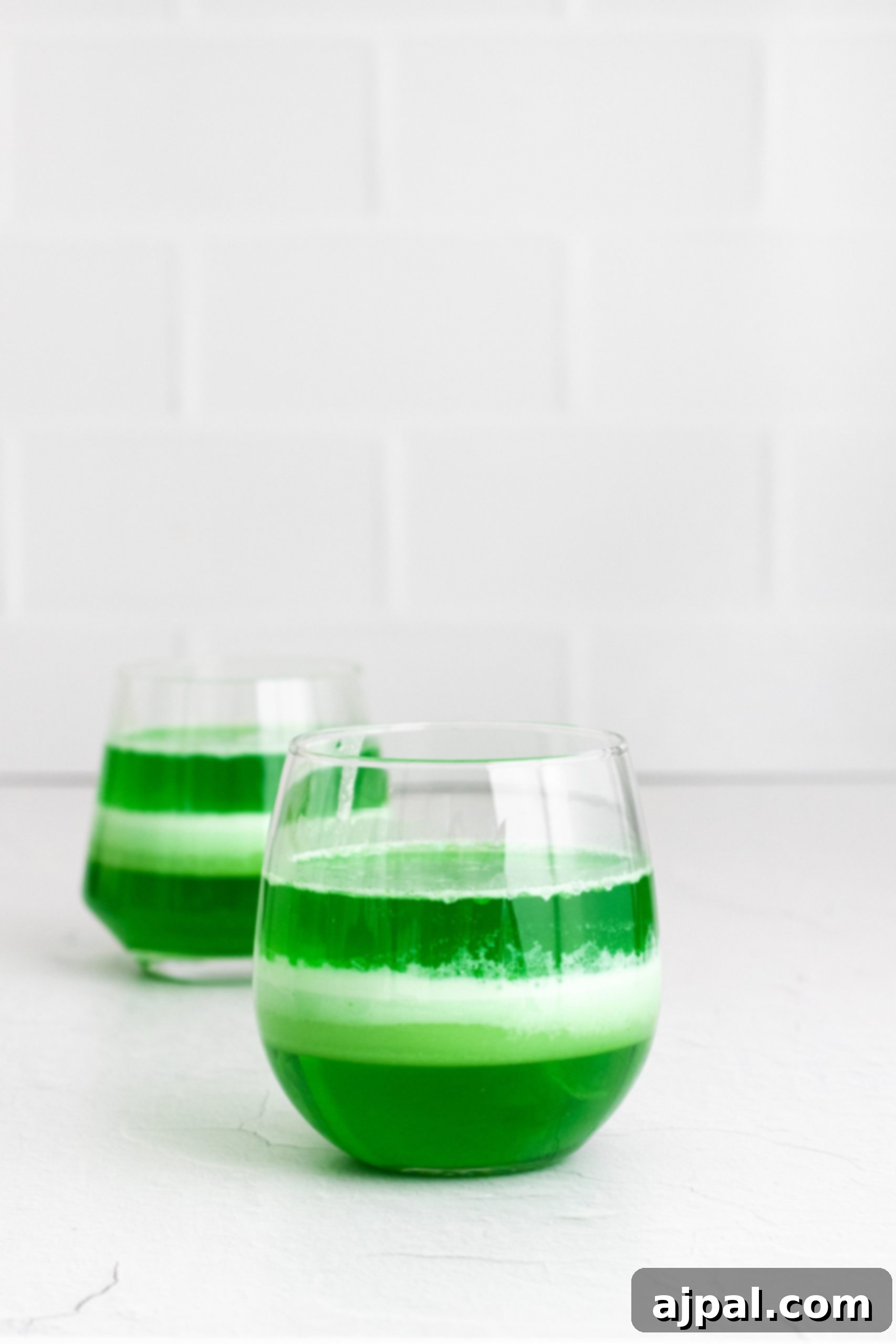 St. Patrick’s Day easy jello dessert with layered green jello in whipped cream cups.