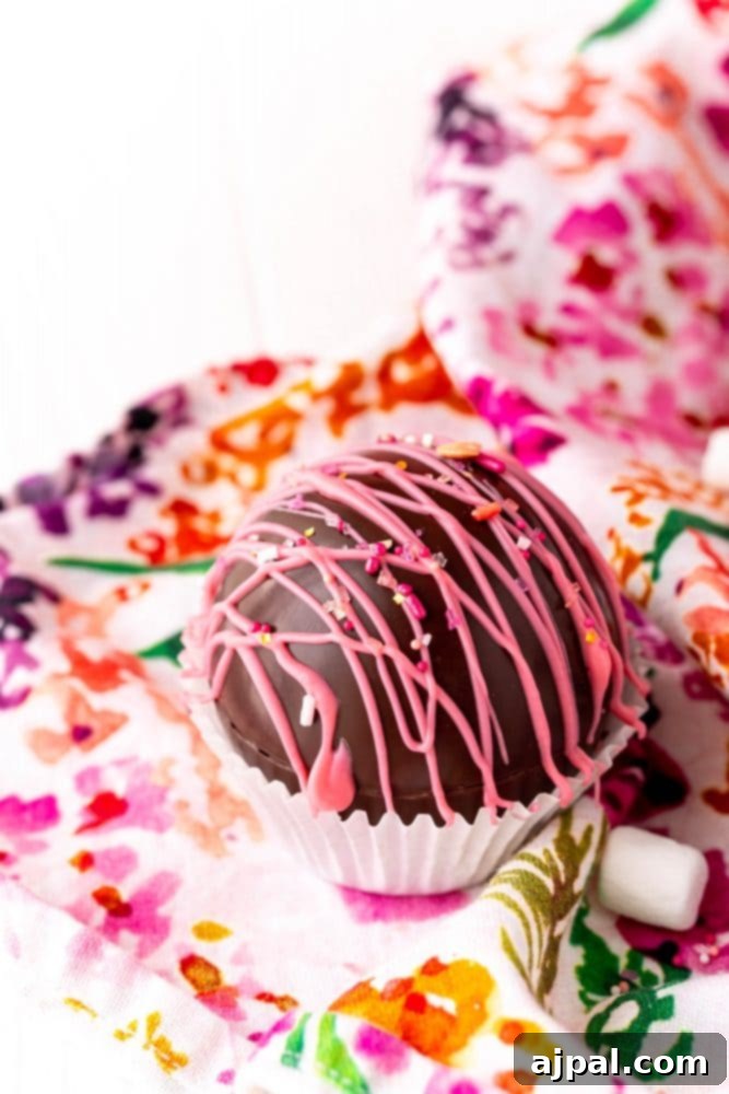 Berry Burst Hot Cocoa Spheres 24 A floral napkin hosts a chocolate dipped marshmallow and a raspberry-infused hot cocoa bomb.