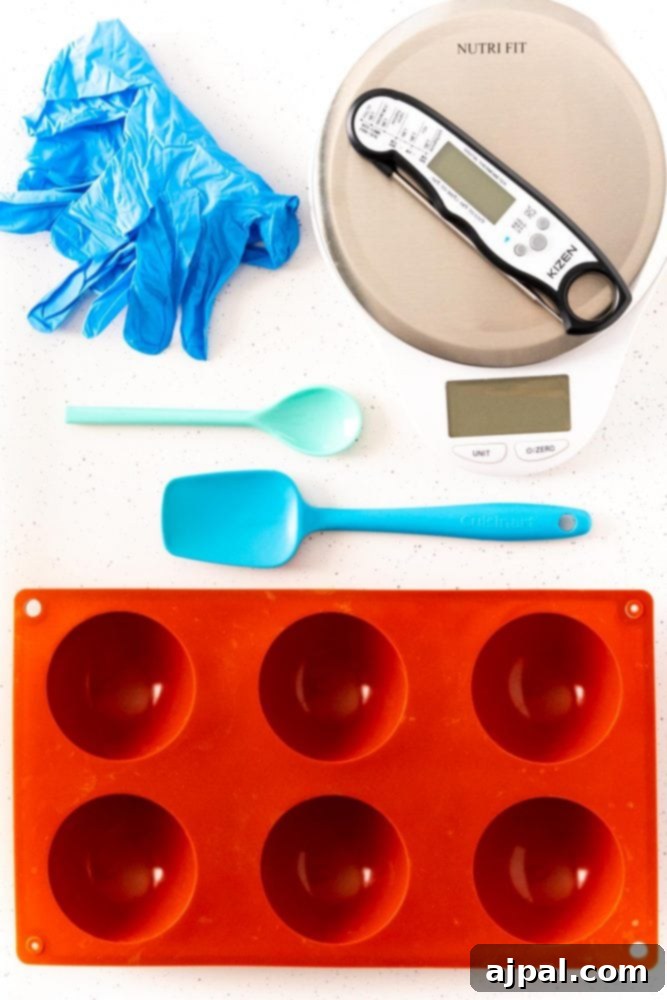 Berry Burst Hot Cocoa Spheres 5 Silicone mold, gloves, spatula, spoon, and temperature gauge for making hot chocolate bombs.