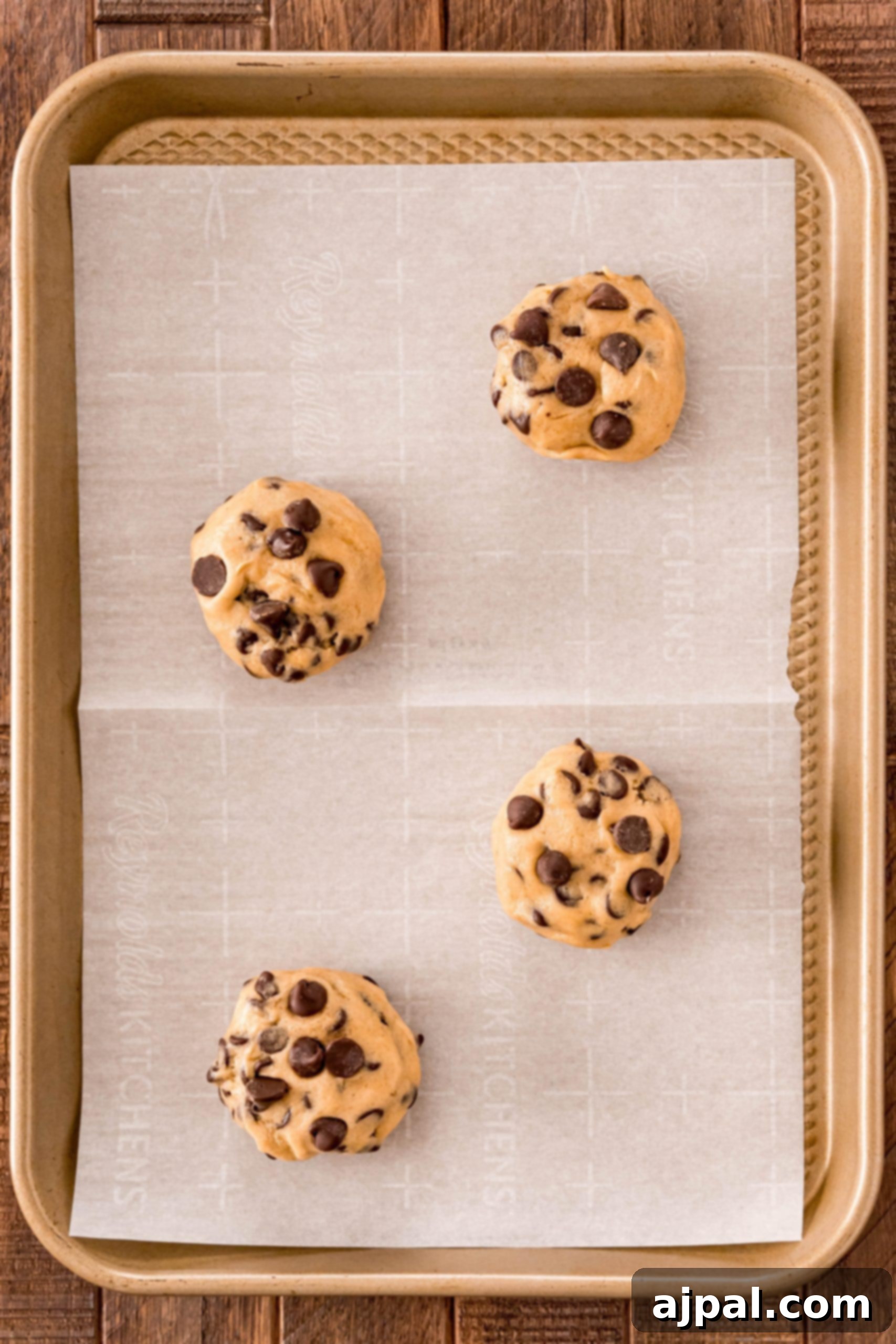 Simple Oreo Stuffed Chocolate Chip Cookies 6 Easy stuffed cookie recipe with four chocolate chip cookies on a baking sheet.