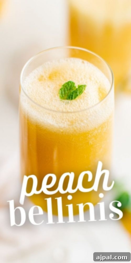 A tall, elegant champagne flute holding a perfectly mixed peach bellini, garnished with a single mint leaf and a slice of peach.