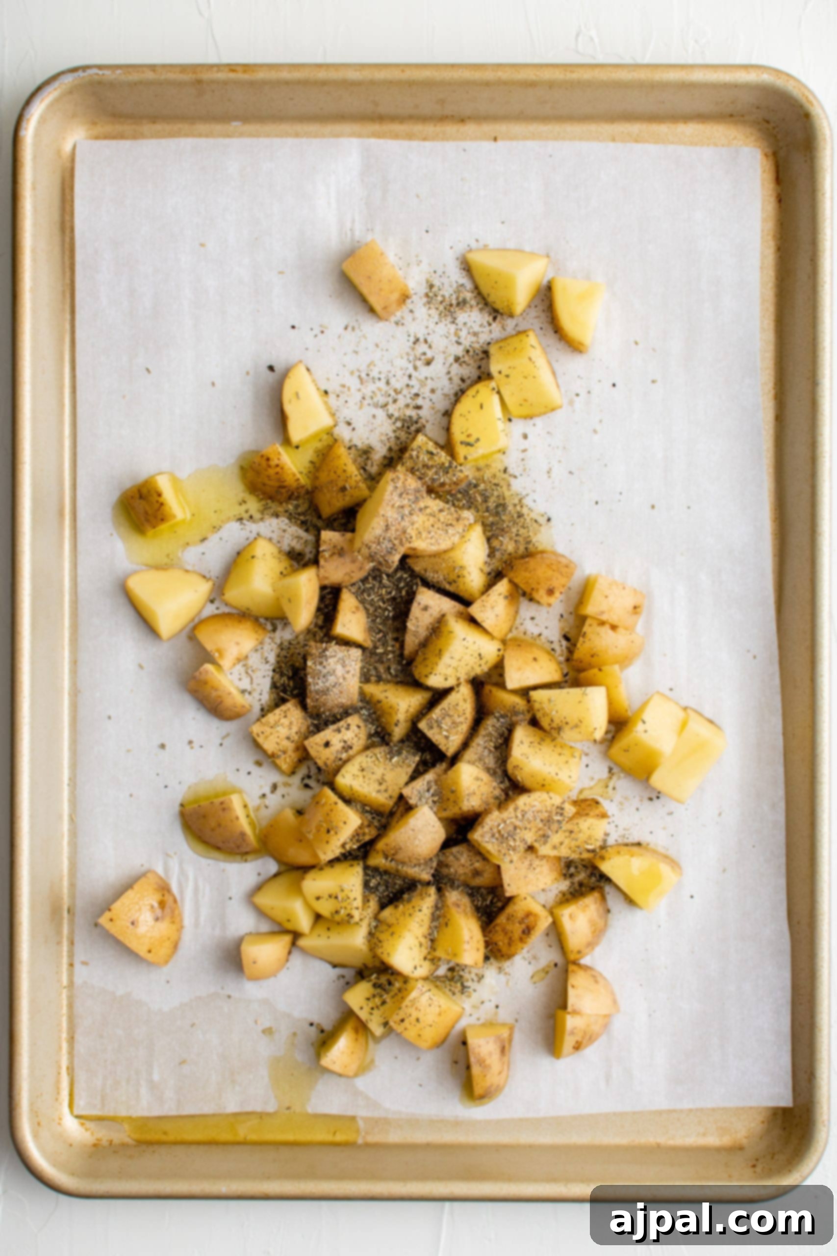 Savory Herb Roasted Green Beans and Potatoes 9 Sliced potatoes seasoned and baked on a baking sheet.