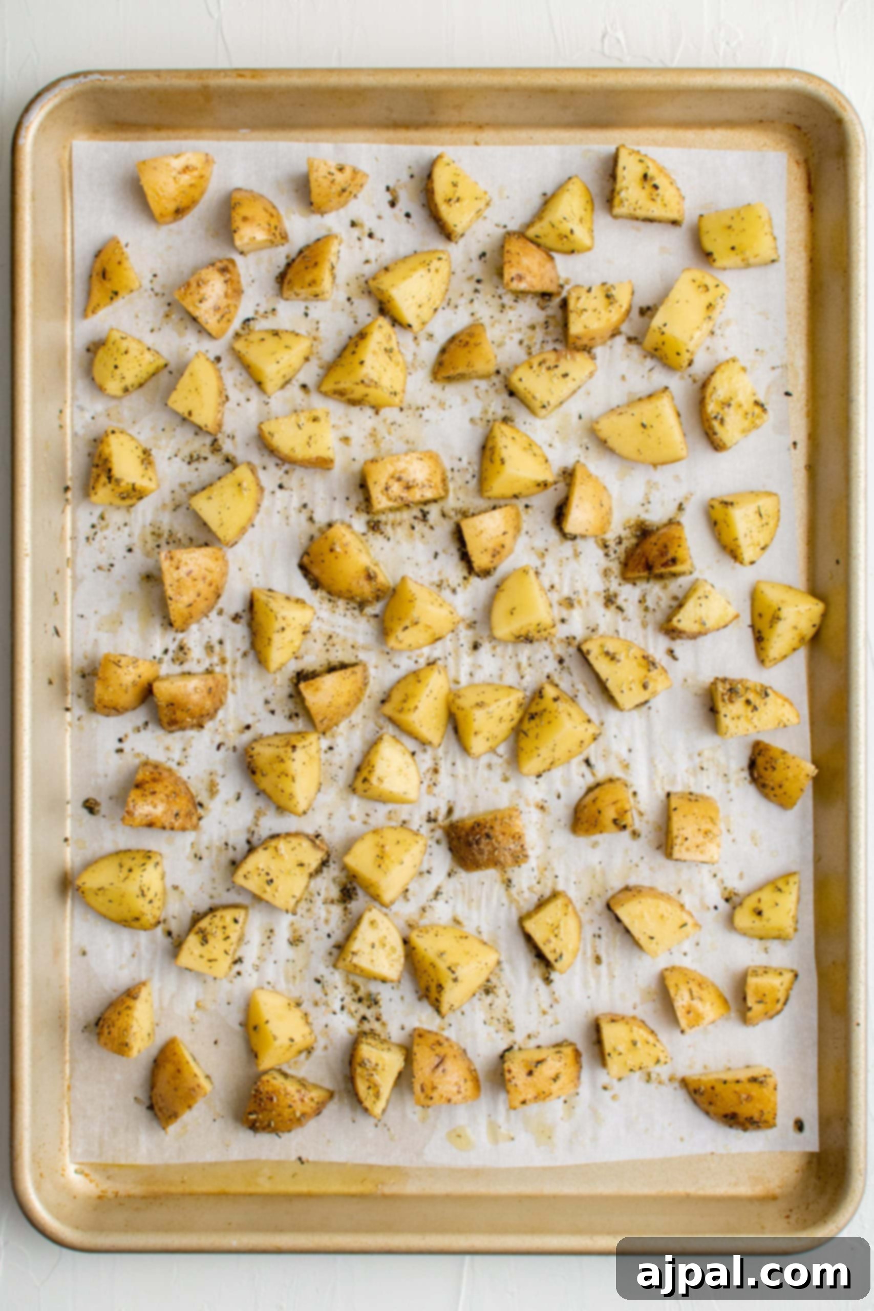 Savory Herb Roasted Green Beans and Potatoes 10 Oven roasted potatoes and green beans on a baking sheet.