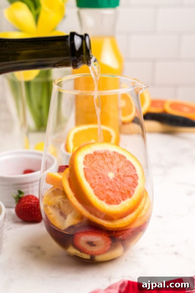 fruit in the bottom of a container with champagne poured onto it
