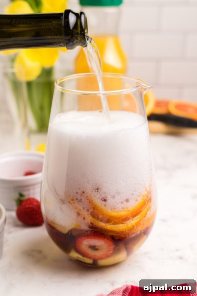 champagne being poured over sliced fruit