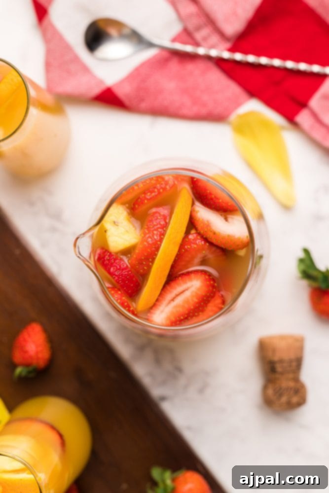 orange drinks in tall glasses with fruit in them