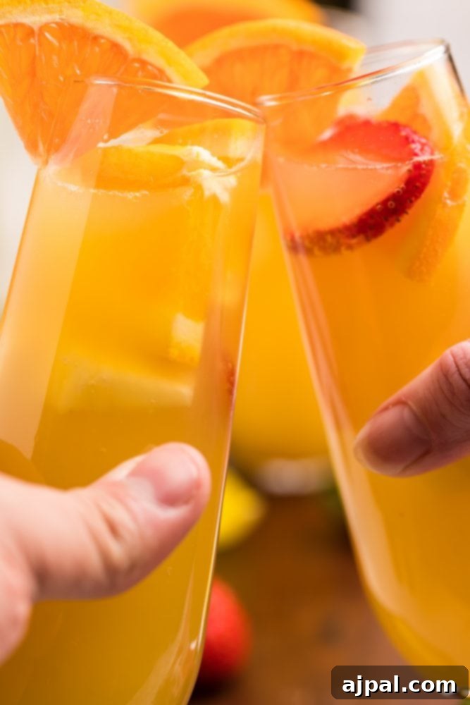 orange drinks in tall glasses with fruit in them 