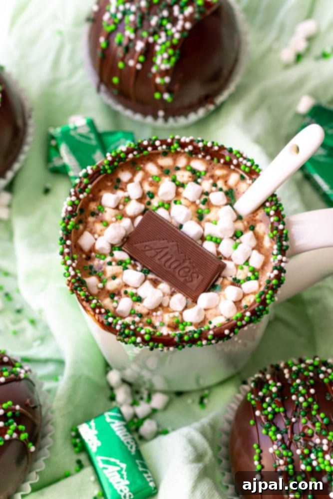 Irresistible Mint Hot Chocolate Bombs 17 mint hot chocolate in a white mug with an Andes mint in it and one on the green base.