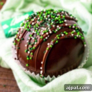 mint chocolate bombs smothered in a cupcake holder with green sprinkles.