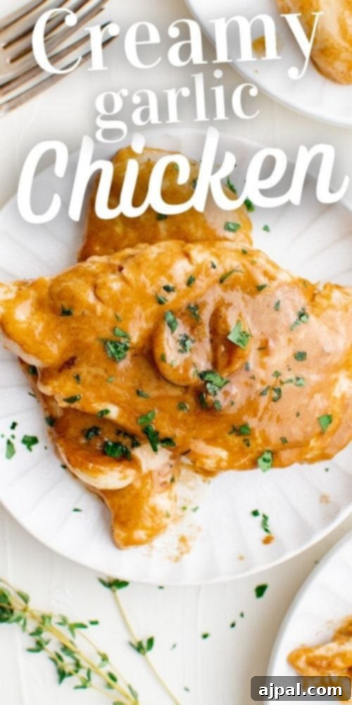 A final presentation of creamy garlic chicken on a plate, garnished with fresh herbs.