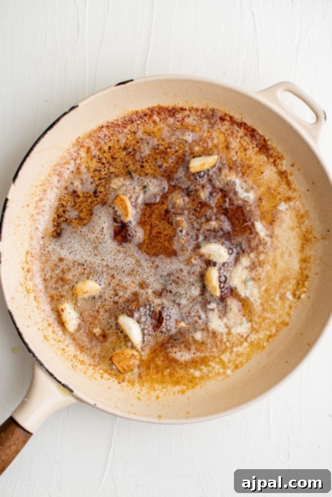 Creamy Garlic Chicken Made Simple 8 A frying pan with chicken in creamy garlic sauce.