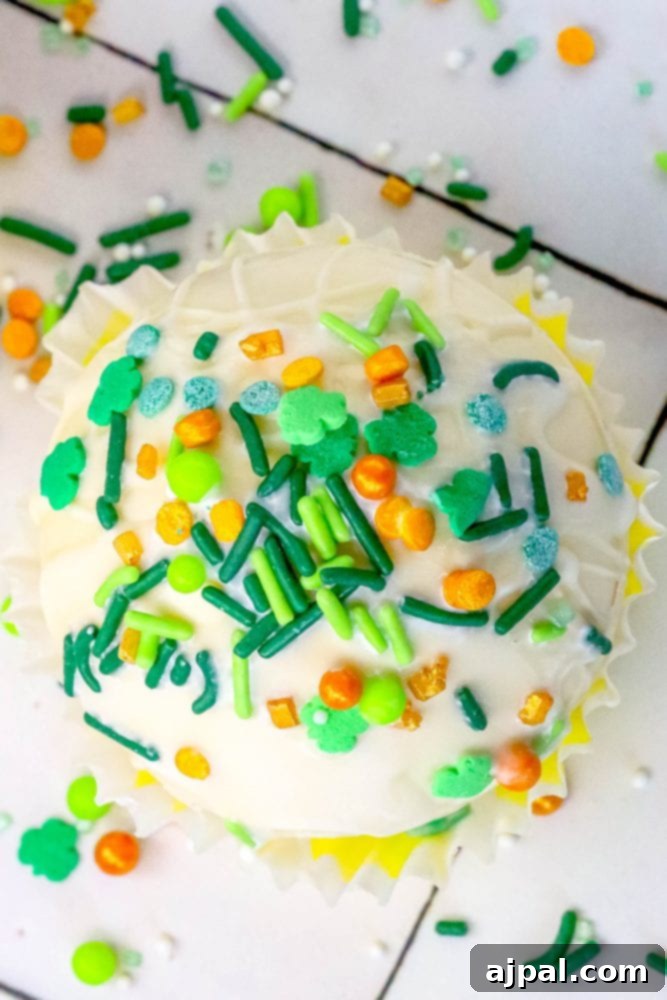 Lucky Green Saint Patrick's Hot Chocolate Bombs 3 St. Patrick’s Day cupcake with green and yellow sprinkles topped with white chocolate cocoa bombs.