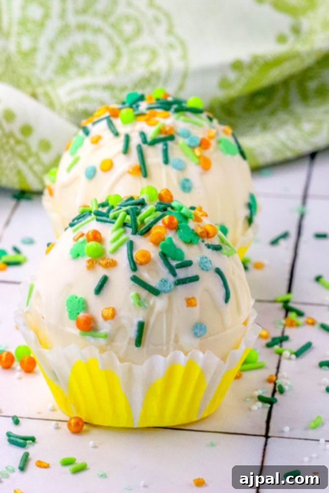 Lucky Green Saint Patrick's Hot Chocolate Bombs 4 white chocolate hot chocolate bombs covered in saint patricks day sprinkles on a table