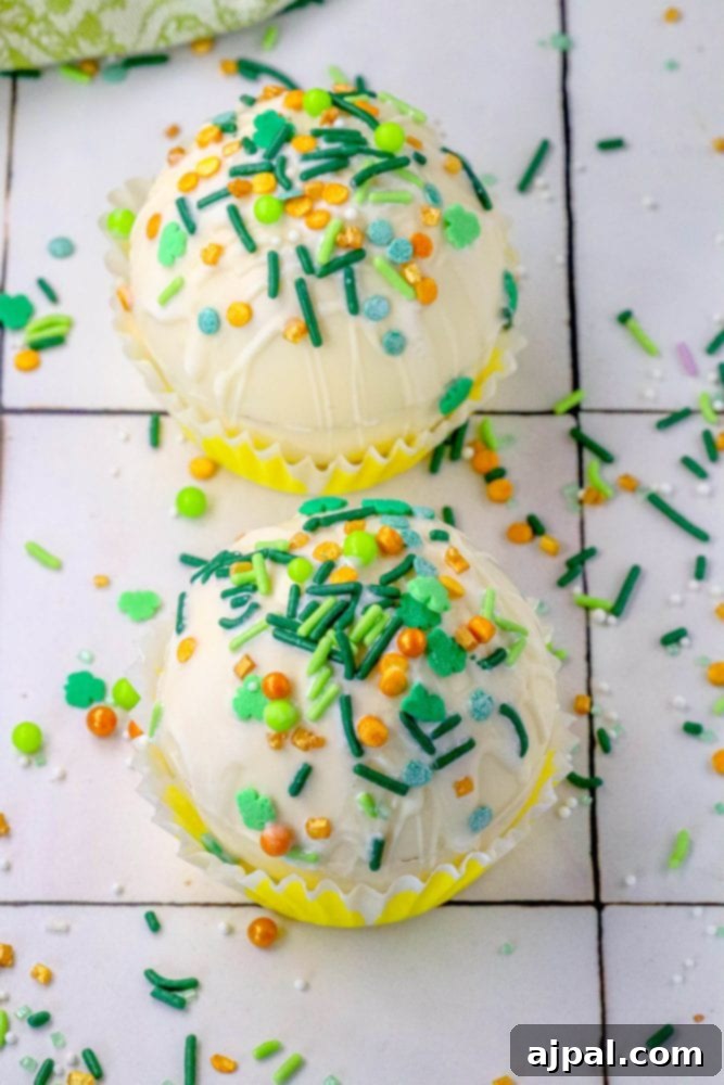 Lucky Green Saint Patrick's Hot Chocolate Bombs 6 white chocolate hot chocolate bombs covered in saint patricks day sprinkles on a table