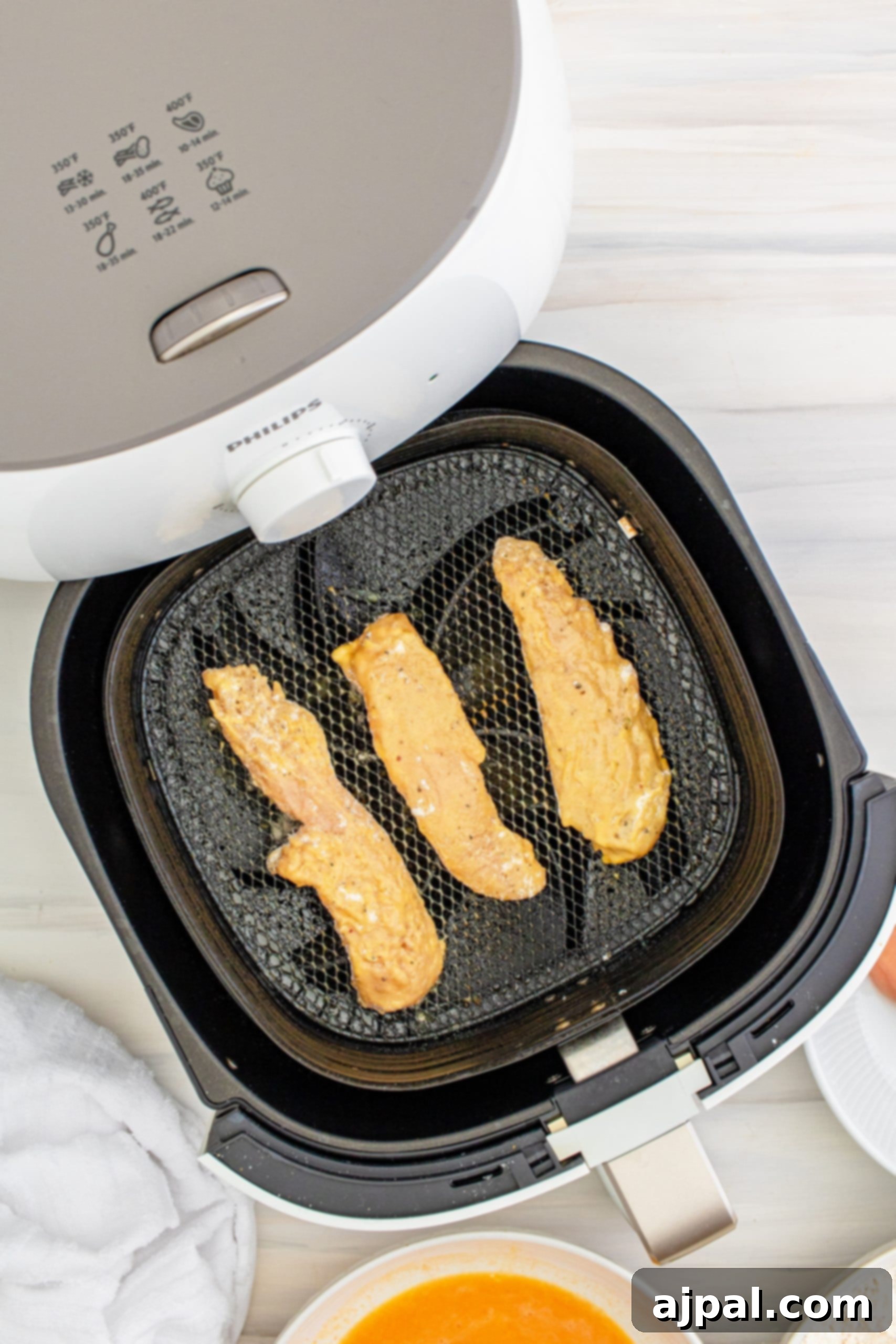 A Philips Airfryer on a kitchen counter, ready for use.