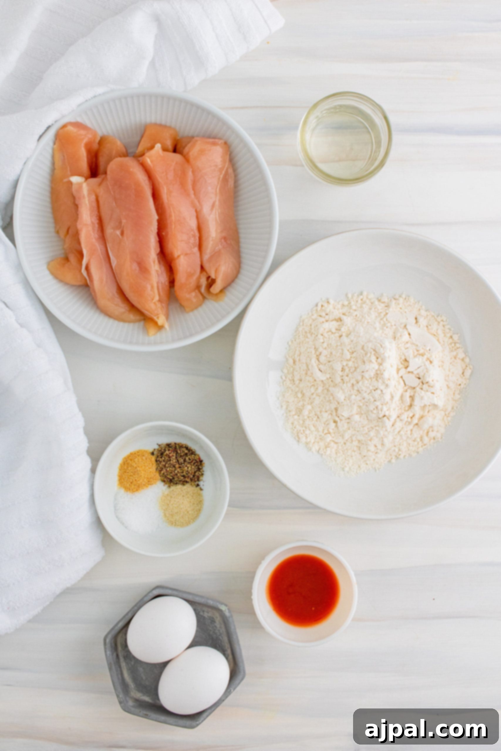 Crispy golden chicken tenders served on a pristine white table.