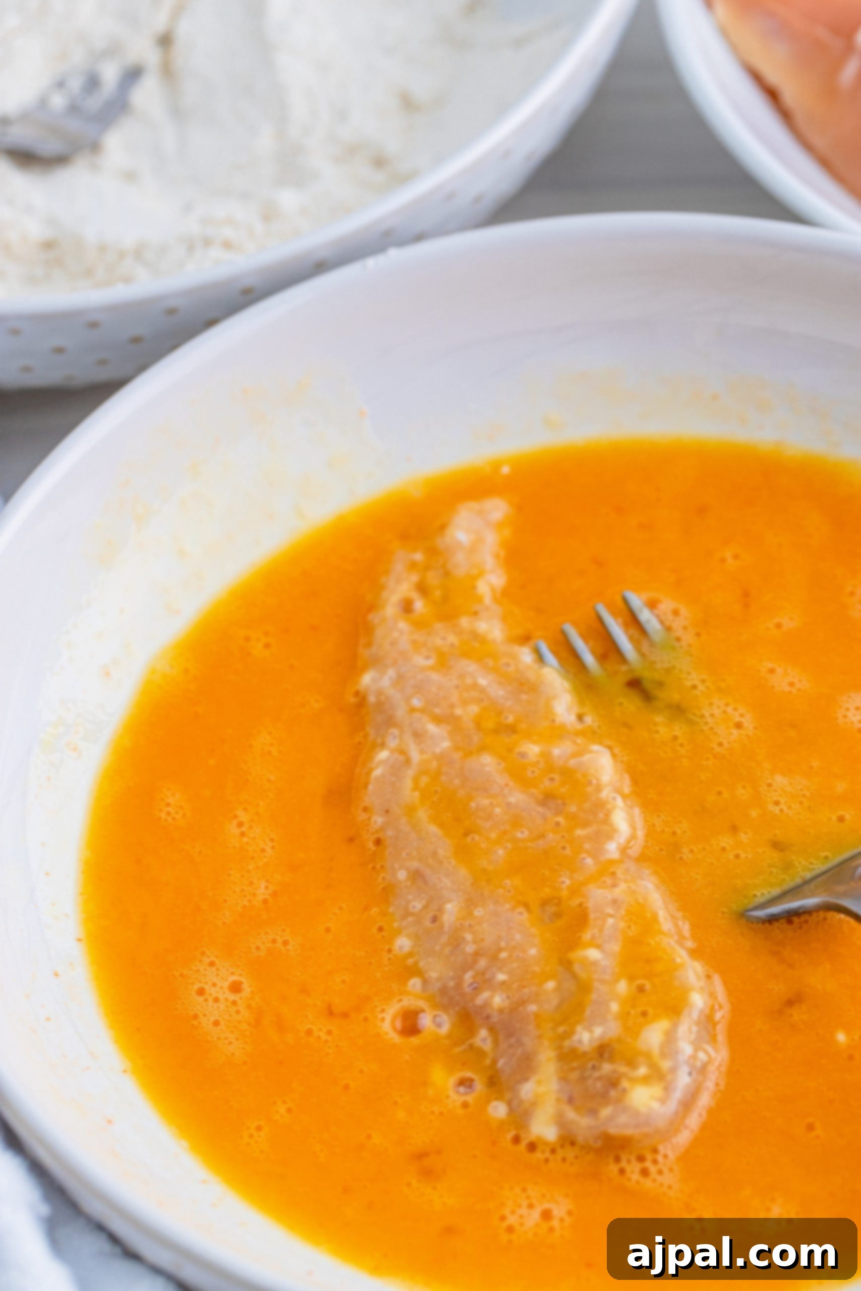 A bowl of creamy dipping sauce, perfect for pairing with crispy chicken tenders.