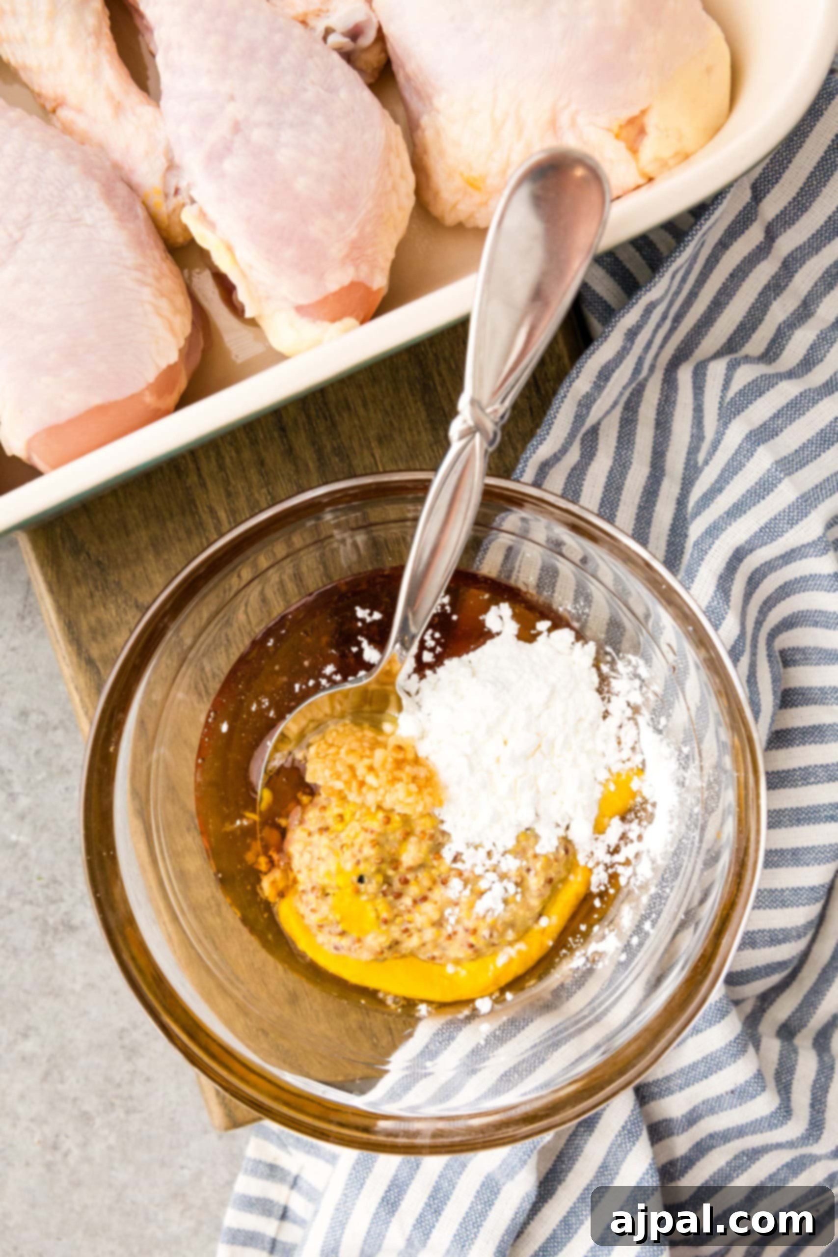 Glazed Honey Mustard Chicken Drumsticks 6 A bowl of chicken drumsticks served with a spoon.