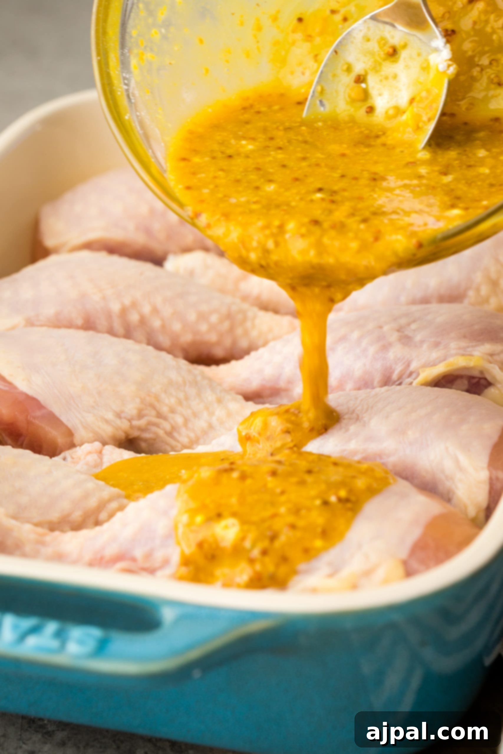 Glazed Honey Mustard Chicken Drumsticks 7 Honey mustard sauce poured over chicken breasts in a baking dish.
