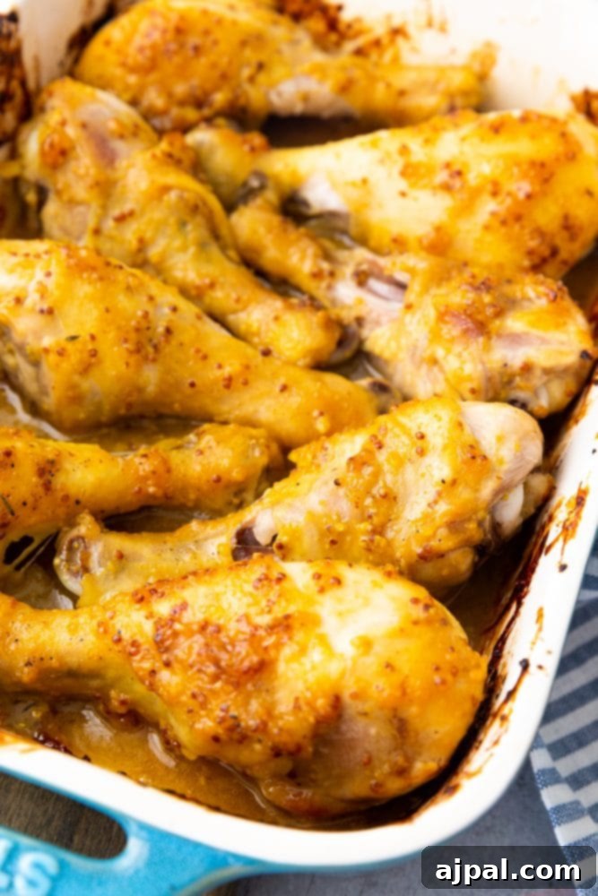 Glazed Honey Mustard Chicken Drumsticks 9 Baked honey mustard chicken drumsticks on a blue tablecloth.