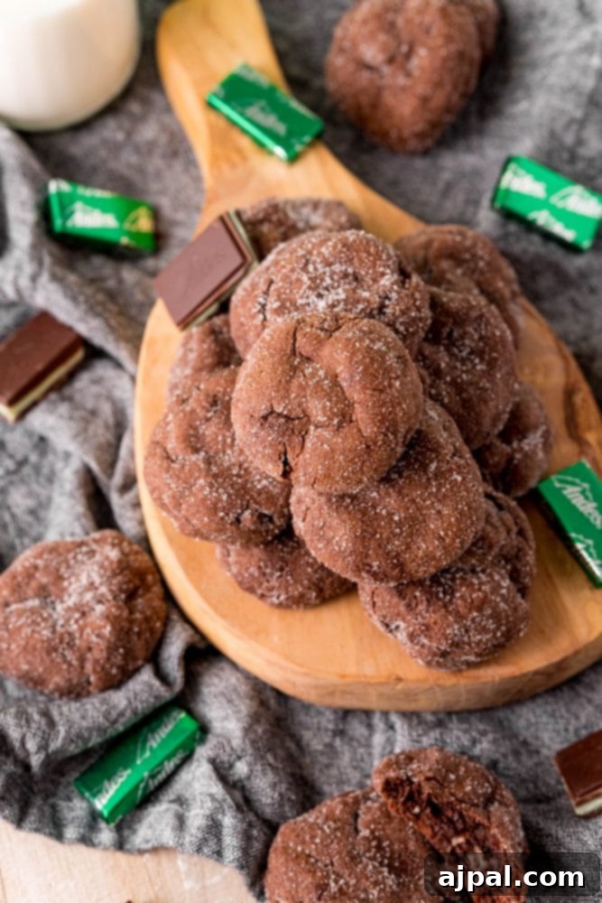 Andes Mint Lava Cookies 2 chocolate cookies stacked on a board with andes mints all over