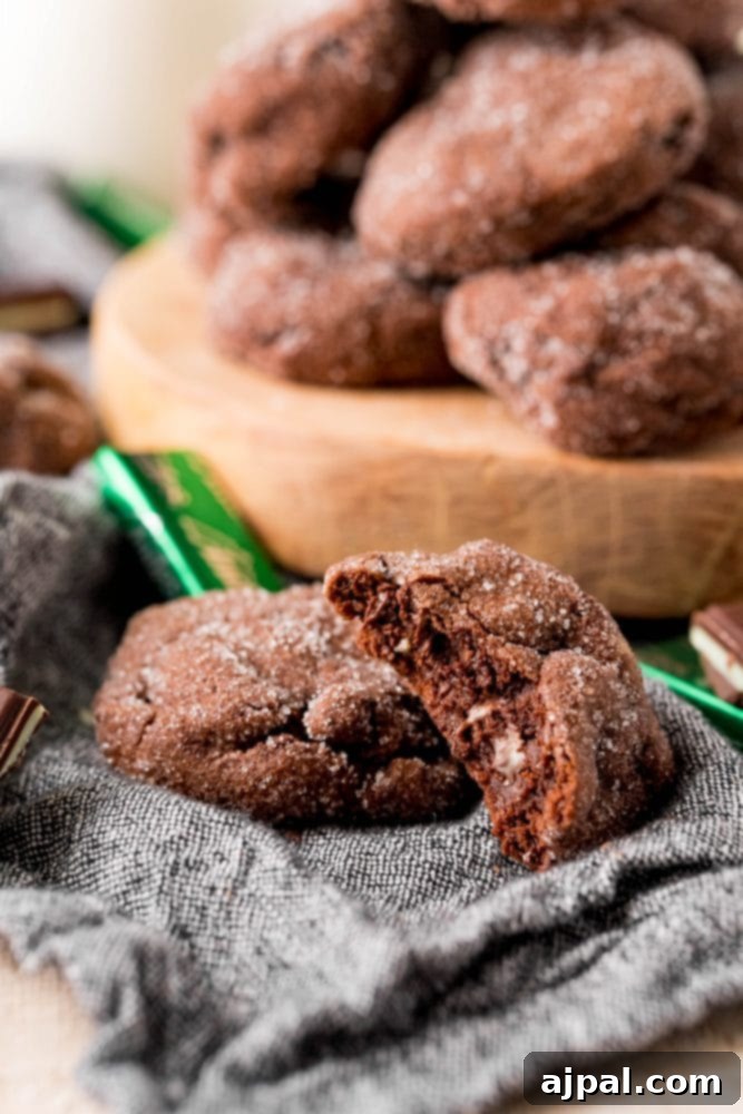 Andes Mint Lava Cookies 11 chocolate cookies stacked on a board with andes mints all over