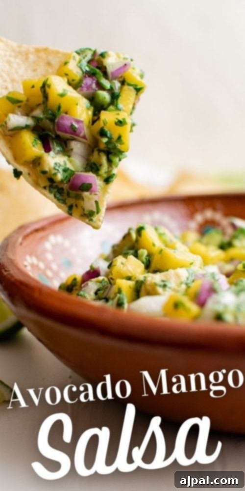 Tropical Mango Avocado Salsa 10 A large serving bowl filled with a generous portion of mango avocado salsa, with a wooden spoon nestled within it, ready for guests to enjoy.