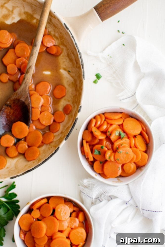 Picture of two bowls of brown sugar glazed carrots and a wooden spoon.