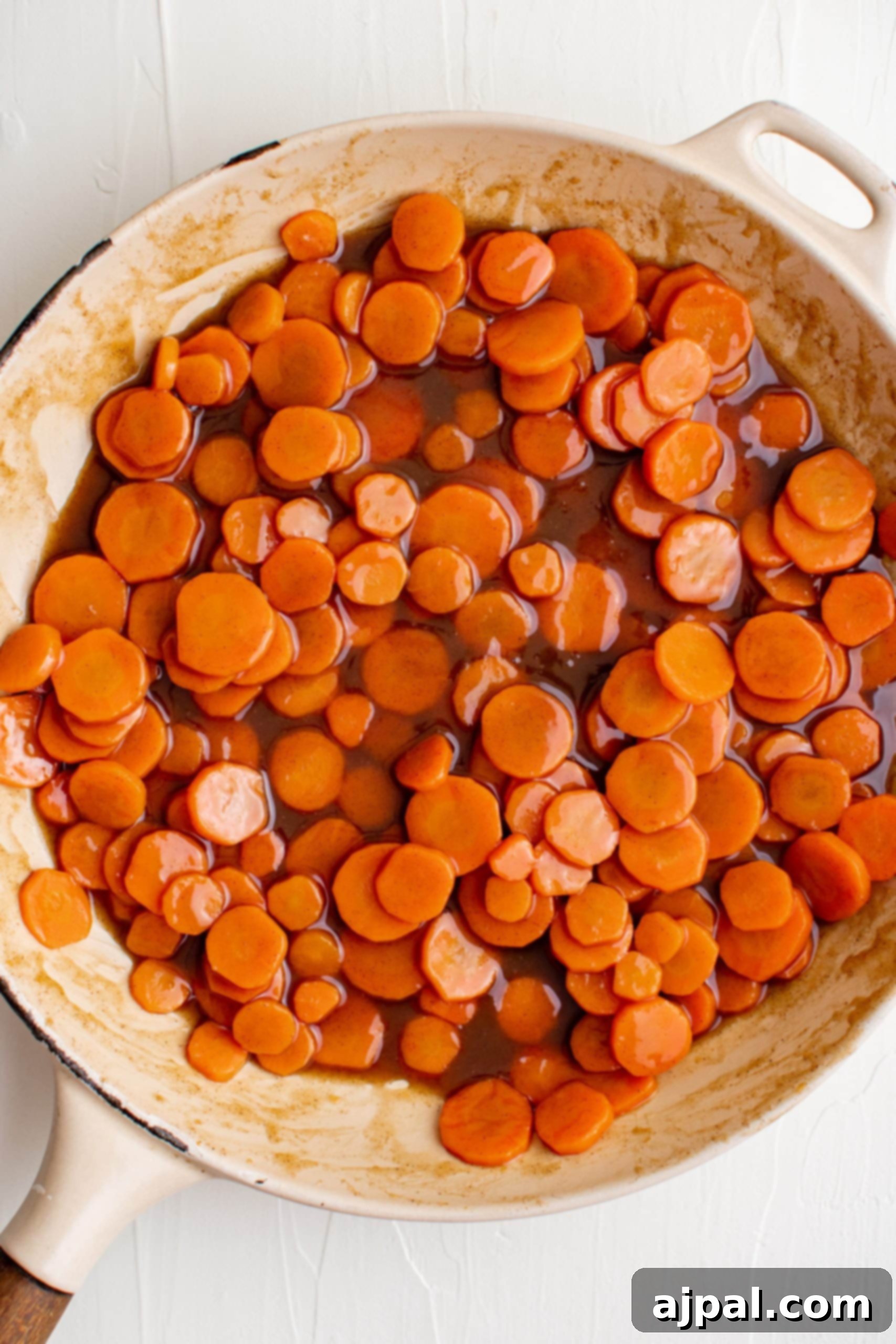 A pan fried carrots in a brown sugar glazed sauce.