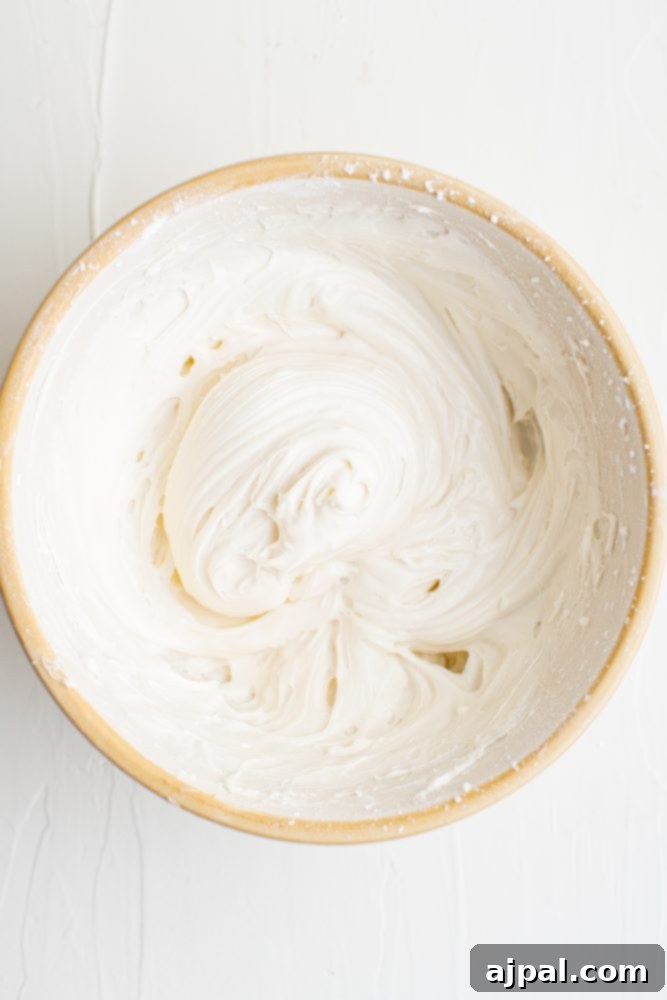 Effortless Fruit Pizza Perfection 12 A bowl of smooth, finished cream cheese frosting, perfectly blended and ready to be spread onto the cookie crust.
