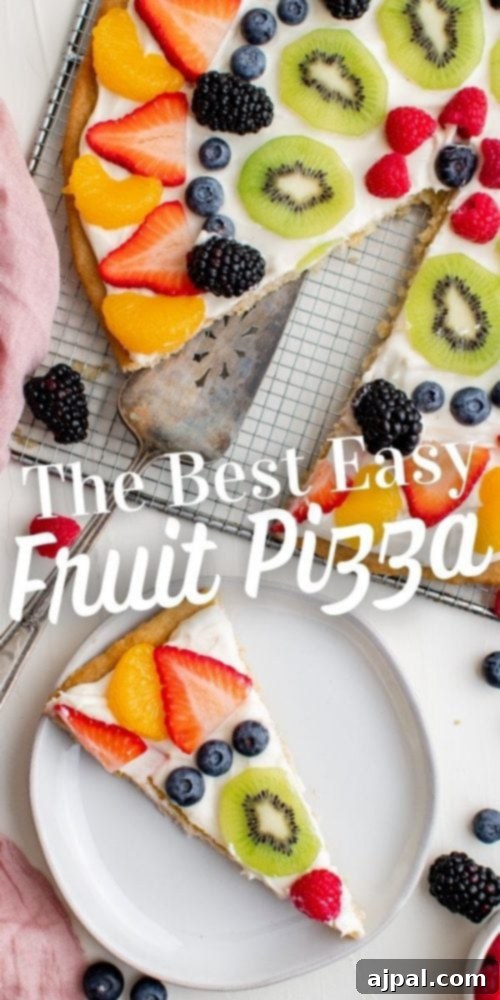 Effortless Fruit Pizza Perfection 20 A stunning, fully assembled fruit pizza with a crisp cookie base, creamy topping, and colorful fruit, presented as a whole with a single slice removed.