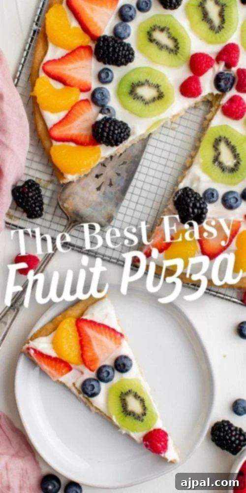 Effortless Rainbow Fruit Pizza 20 A stunning, perfectly sliced fruit pizza, showcasing its golden cookie crust, creamy white topping, and an array of colorful fresh fruits.