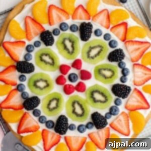 An easy homemade fruit pizza topped with berries and kiwis.