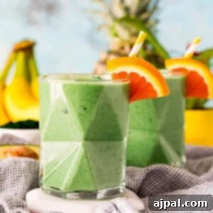 Sunshine Green Smoothie Boost 9 tropical blended smoothie on a table